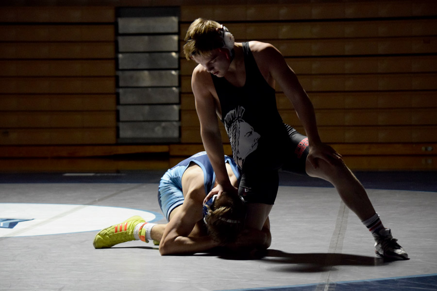 Working on a escape, junior Josh Newton (152) tries to get to his feet. Newton won his dual match against Oak Park. The Indians won the dual 42-33.