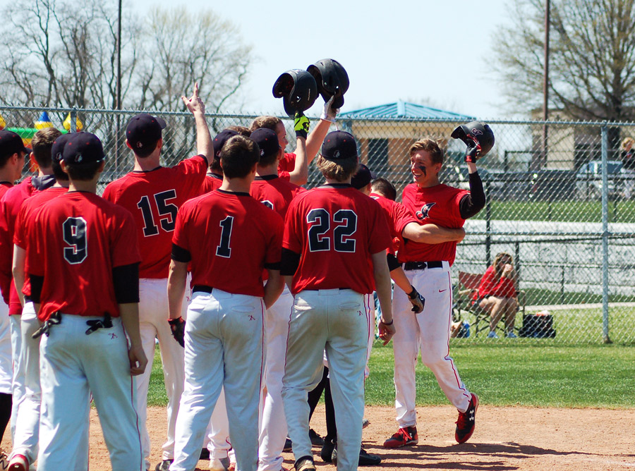 The Indians' baseball team celebrates senior Nick Dye's (Far Right) first home run of the season. The Indians hit two home runs in the game but lost to Park Hill 15-12.