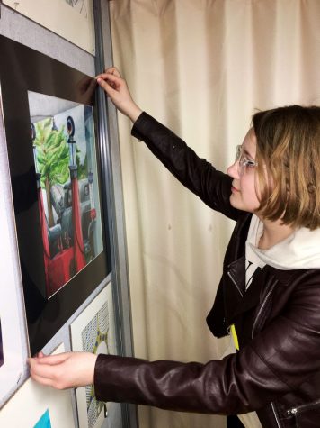 Getting it just right, Junior Allison Gant adjusts a print of her award winning art work,