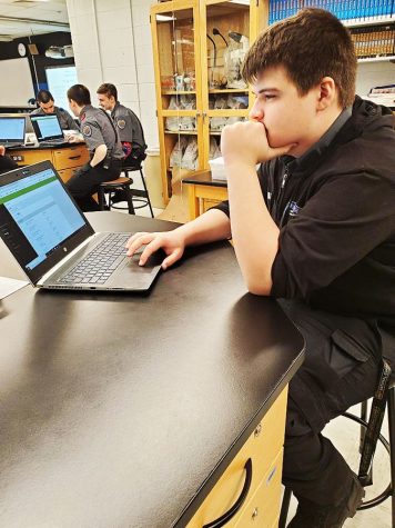 Junior Tyler Sharp checks his schedule on the updated Infinite Campus software. The new software automatically sets schedules based on an algorithm.