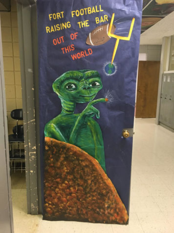 Students and teachers decorate doors for Homecoming