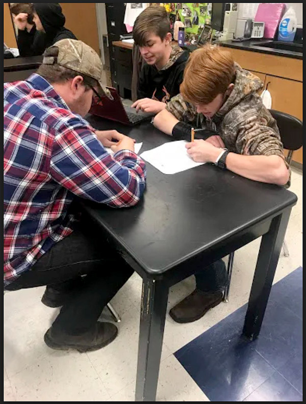 Freshmen Sebastian Wolfe,  Clayton Yewell and Clayton Gist work on a project in Physical Science class. The three celebrated Destination Day by wearing country apparel.