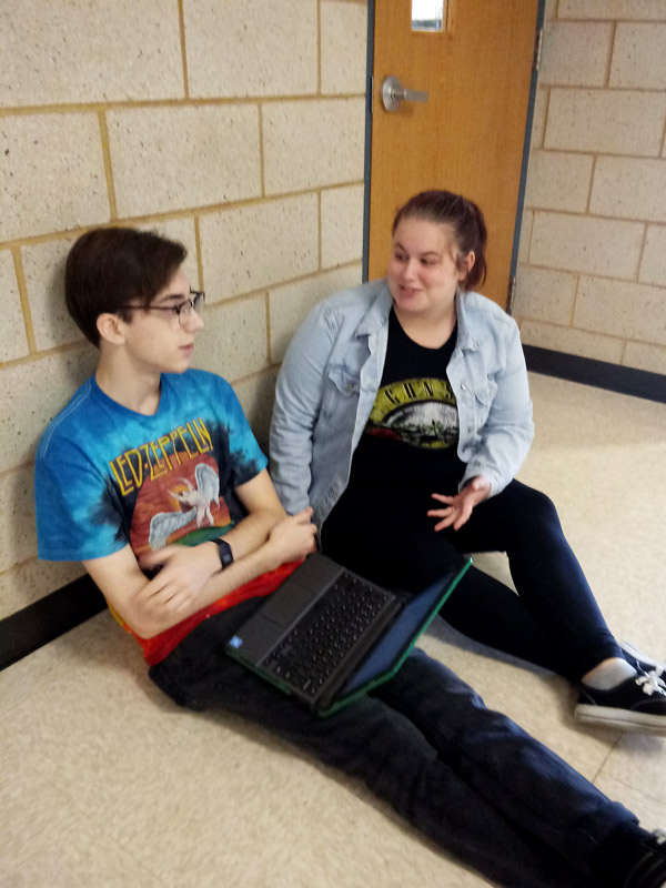 Seniors Zack Isbell and Ashley Godfrey discuss a literature project outside Ms. Amanda Shropshires room during 2nd period. Godfrey is scheduled to graduate at the end of the fall semester and plans on attending Penn Valley in the spring.