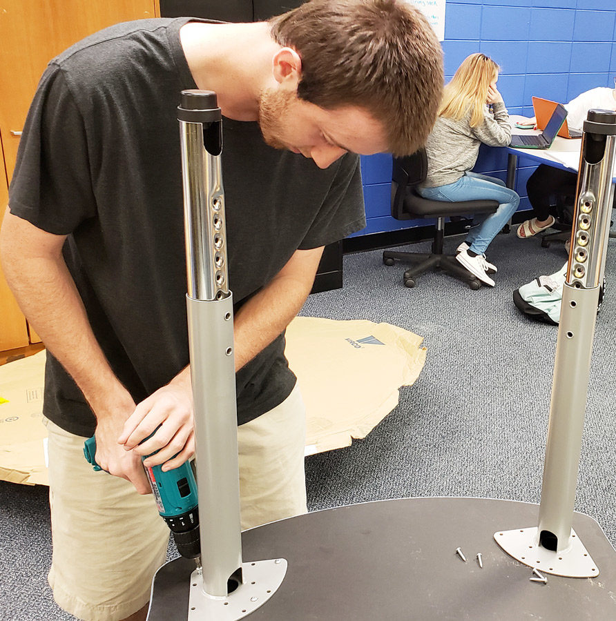 Senior Advanced Marketing student Jared Larson assembles a table for his classroom at the Career & Technical Center. The CTC is celebrating its 50th anniversary on Oct. 3, 2018.