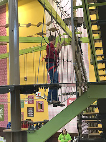 Junior Alex Zachgo traverses the team building obstacle at the 91st Annual FFA Convention in Indianapolis, IN. Eight students from the school attended the event Oct. 24-28.