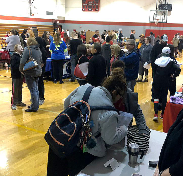 Parents and their rising 9th grade students browse the small gym to visit with teachers and activity advisers at the Incoming 9th Grade Preview Night Feb. 26.