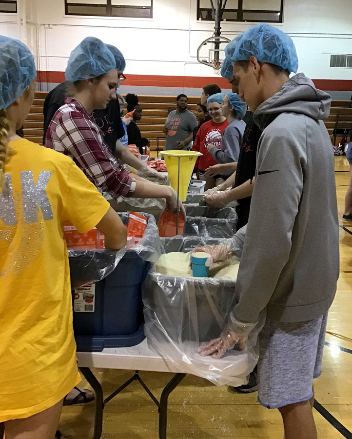 Filling bags with  food, students help with the Feed the Funnel service project during the 3rd annual Fort Serves Day of Service. Students could help serve the community at eight different locations.