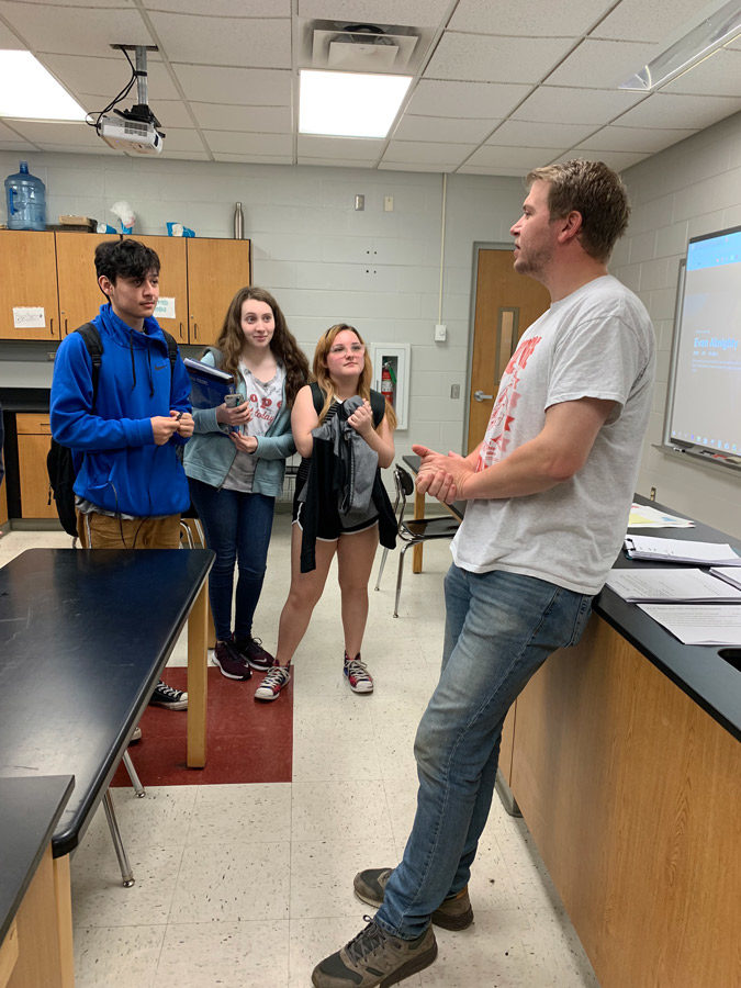 Finishing up a class, Mr. David Moore talks with freshmen Emme Jeffries, Kelsey Yocum and Linsey Hull as they leave. Mr. Moore and six other teachers/staff are leaving for other jobs at the end of the year.