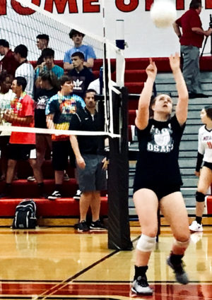 Senior Ciera Cory sets a ball during warm ups at a recent match. She hit her 1,000 career assist on Oct. 3, 2019.