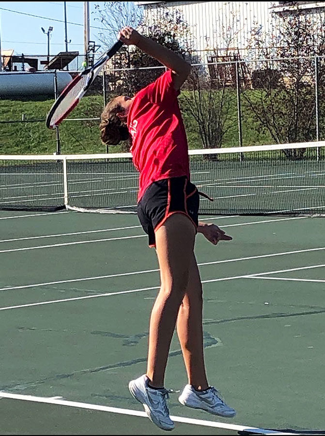 Striking+the+ball%2C+junior+Dharma+Craig+delivers+a+serve+in+her+doubles+match+at+the+Class+2+District+15+Girls+Tennis+Tournament+Oct.+7.+The+team+won+their+first+round+match+5-1+over+North+Kansas+City.