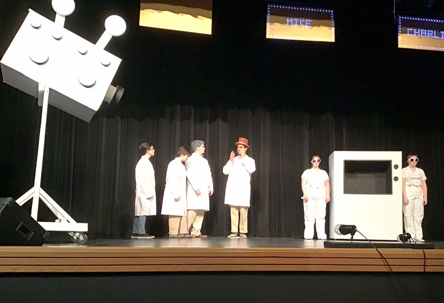 Giving instructions, Willy Wonka, (center) played by senior K.J. Pau, directs his technicians (L to R) sophomores Grant McDaniel, Emmie Esch, Brendon Johnson, senior Annah Garrison and junior Kelsie Clark to demonstrate Wonka-vision. The Musical Willy Wonka will perform at FOHS in the PAC Nov. 21-23 at 7 p.m.