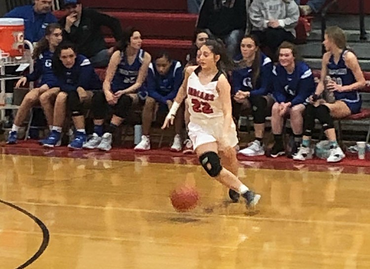 Dribbling the ball, senior Sophia Cornett moves to the top of the key to set up the offense. She has scored 40 points on the season for the Indians.