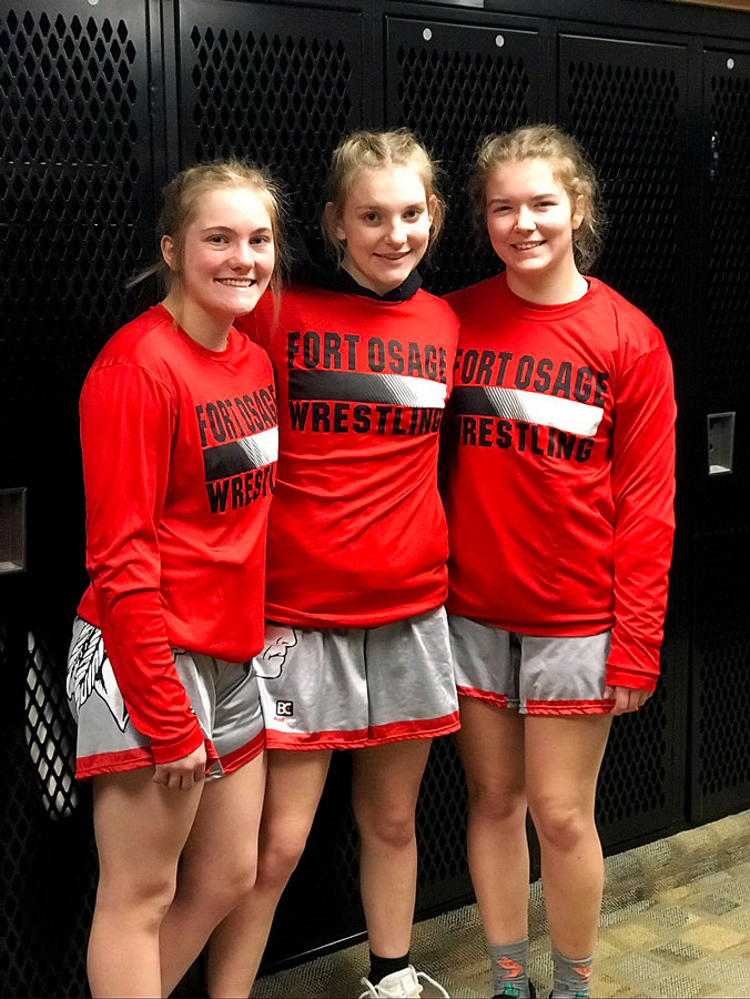Senior Tess Kinne, freshman Haley Ward and senior  Rachel Rellihan prepare for the State Tournament. The girls team finished 11th with 39 points.