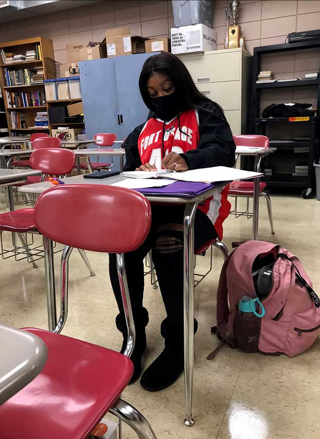 Dressing up. Working during class, Senior Aspen Treadwell shows her spirit on Dress like an Athlete/Mathlete Day. Students were encouraged to celebrate Halloween and the NFHS Virtual Haunted House the week of Oct. 19-23.