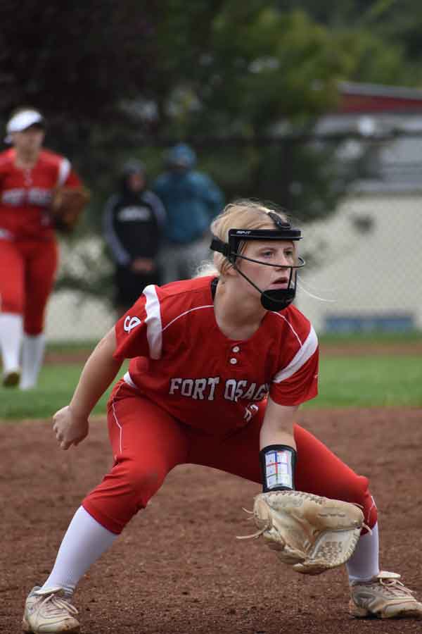 Ready. Crouching down, 3rd base player Junior Alysa Garlock anticipates a ground ball coming her way. Garlock ended the 2020 campaign with a .393 batting average, 2 homers and 31 RBIs.