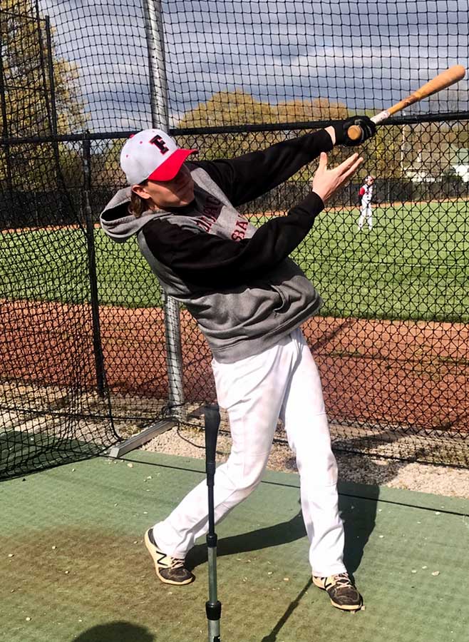 OFF THE TEE. Following through, Senior Michael Dieckman finishes a swing during warmups. Dieckman catches and is a designated hitter for the Indians baseball team.