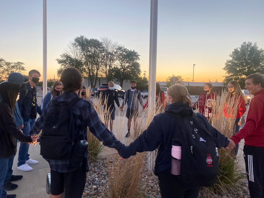 PRAY: Gathering around the stadium flag pole, students hold hands and pray for the school and community. The annual See You at the Pole event took place on Sept. 22, 2021.