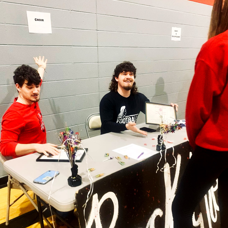 TRY US. At the 9th Grade Preview Night, Sophomores Lake Sullivan (L) and Landon Sullivan help a rising freshman learn about the choir program at the high school. Choir is a co-curricular class and provides a fine art credit towards a students  graduation requirement.
