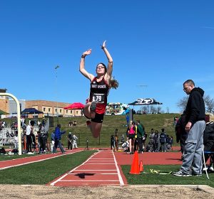 LEAP. Flying off the runway, Senior Dawn McIntyre attempts a long jump at the 60th Annual Bill summa Invitational hosted by William Chrisman High School. McIntyre placed second in the event with a jump of 5.09 meters.
