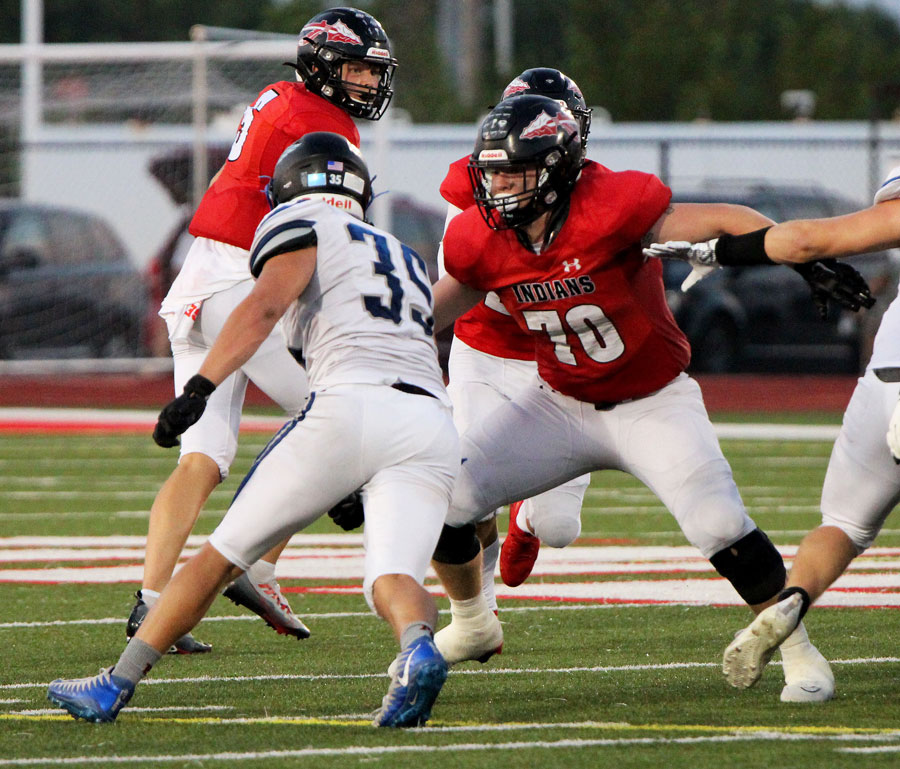 BLOCK. Sticking his arms out, offensive right tackle Senior Jayce Kern (70) blocks defensive end Collin Burd (35) during a pass play. He has helped the team amass 3,524 yards so far this season. “Its kinda sad with it being my last year playing for Fort Osage since Ive done it my whole life,” Kern said.