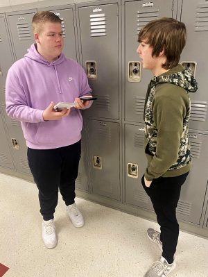 INTERVIEWING. Senior Logan Crabtree (L) is interviewing Freshman Gabriel Rippey (R) for a quote in the yearbook. Crabtree has spent the past two years of high school participating in the yearbook program. “I love yearbook because it gives me a chance to take pictures and to meet new people while interviewing.”