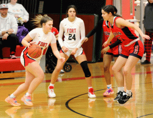DRIVING THE LANE. Looking up the court, Senior Ashyln Buntin (11) challenges Truman’s Cece Mora (21) while  Macie Smith (24) anticipates a pass. Buntin’s favorite basketball memory was the team dinners. “Its sad knowing this is my last year at Fort Osage,” Buntin said.