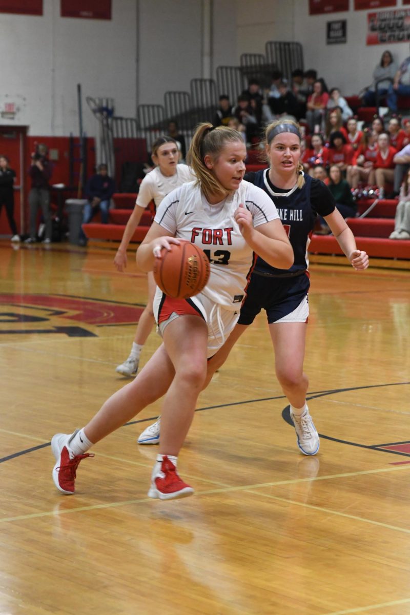 DRIBBLING. Senior Emmah Crowe drives the ball to the hoop. Crowe loves the community and team aspect of the game. Just finding a really big family, I gain 31 sisters every new season, Crowe said. 