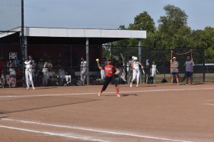 THROWING TO FIRST. Senior Neveah Wilson winds back to throw a runner out at first base.