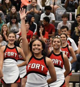 Kylie Corum, senoir, performs with the cheer squad during the Homecoming assembly.
